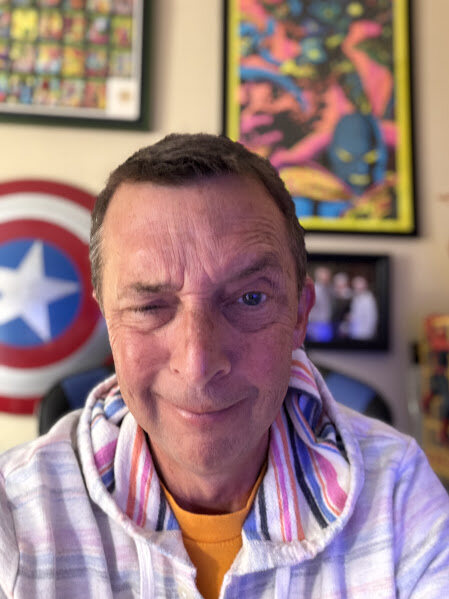 Sean standing in a room decorated with comics and pop-culture art